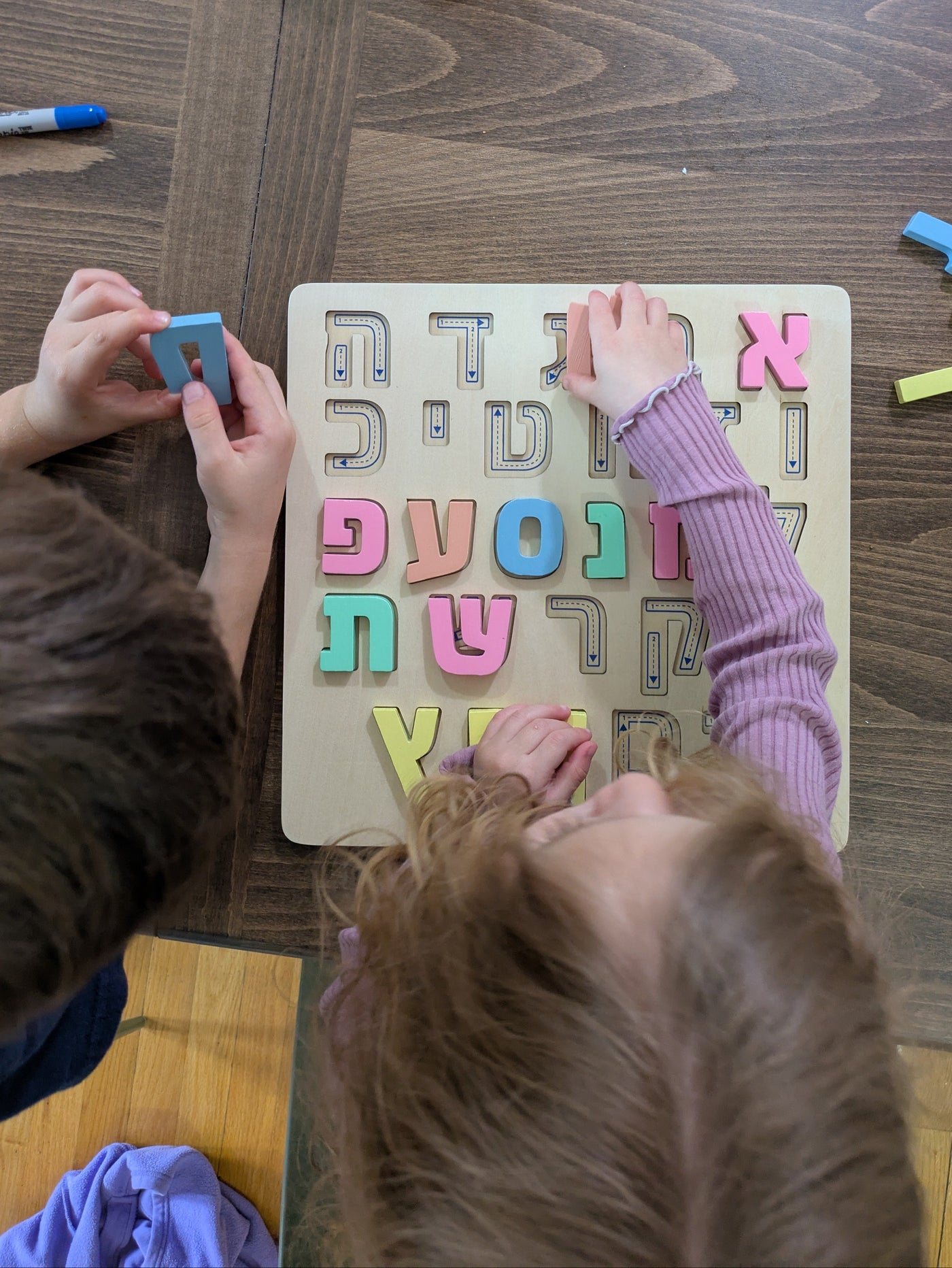 Two children learning Hebrew together with Speakyti wooden alef bet puzzle. Montessori speech therapist-designed toy for toddlers and preschoolers, ages 3+